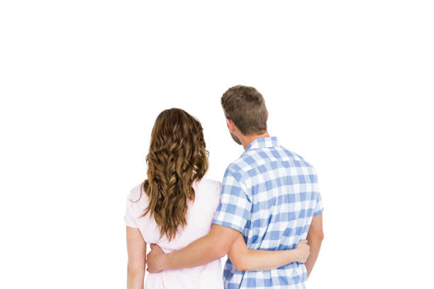 istock Rear view of young couple embracing 673216102