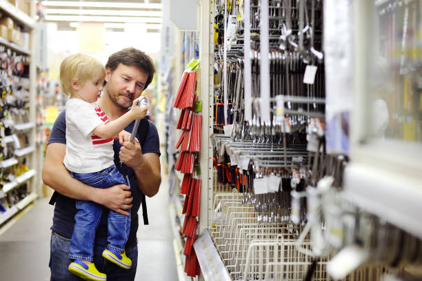 istock Father and his son choosing the right tool in a hardware store 673222898