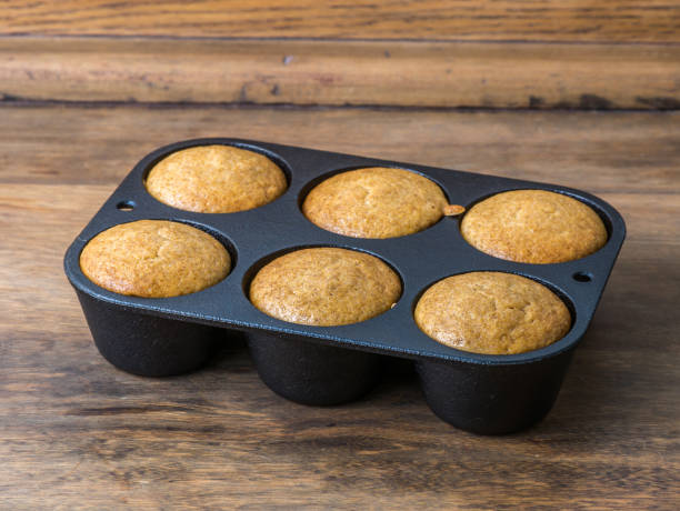 istock Six homemade muffins in a cast iron baking pan 673223188