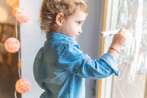 istock Beautifull little girl drawing 673225962