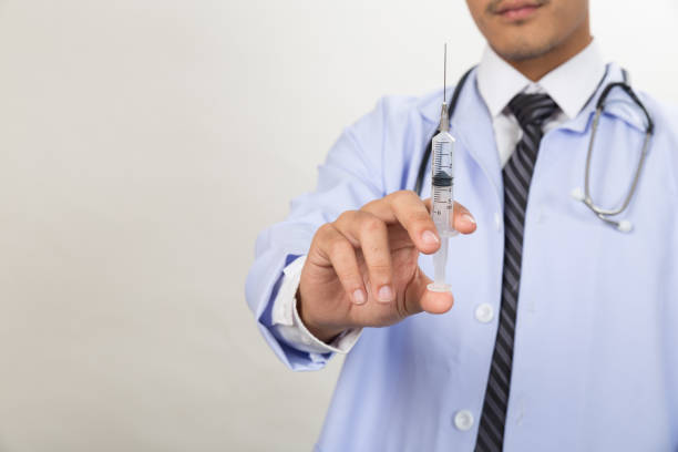istock Doctor with syringe is preparing for medical injection 673233084
