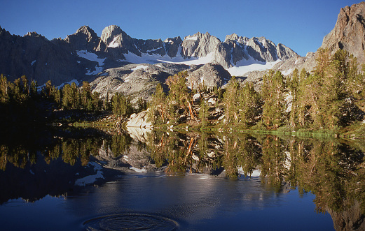 The Palisade Crest of the Sierra Nevada Mountains with Mount Sill the highest prominent peak and mountain lake early morning Big Pine California
