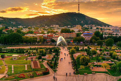 View of Rike Park with Bridge of Peace at sunset. Center of Tbilisi city, Georgia