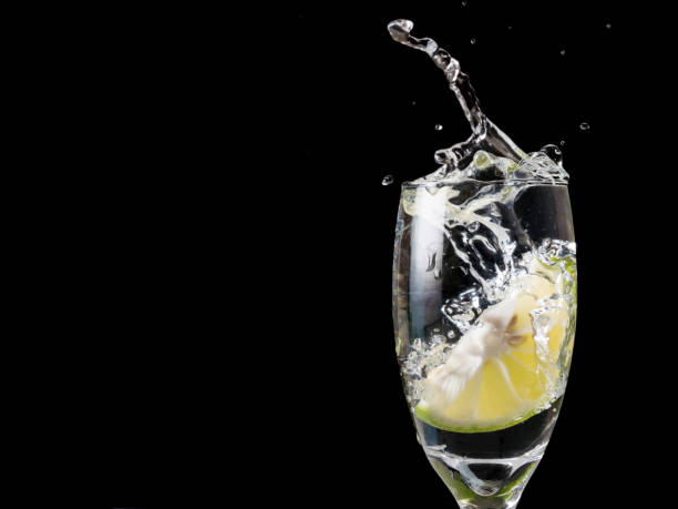 istock Glass of water with lime on black background. 673262756