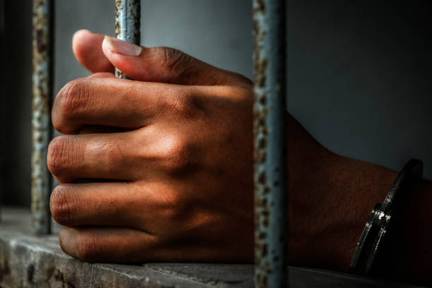 istock Prisoner holding metal cage 673269480