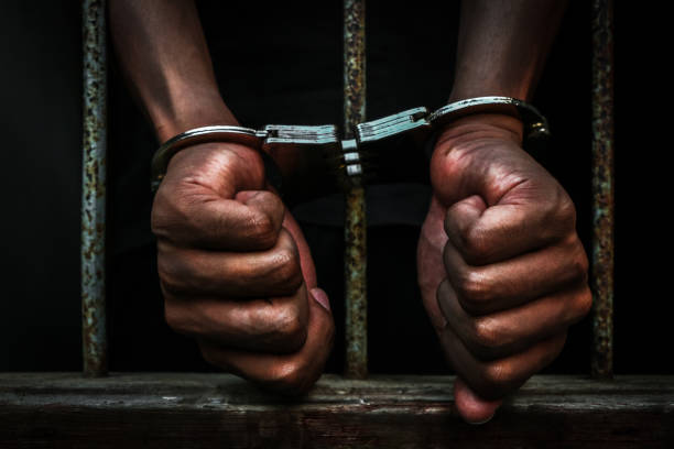 istock Prisoner holding metal cage 673269486