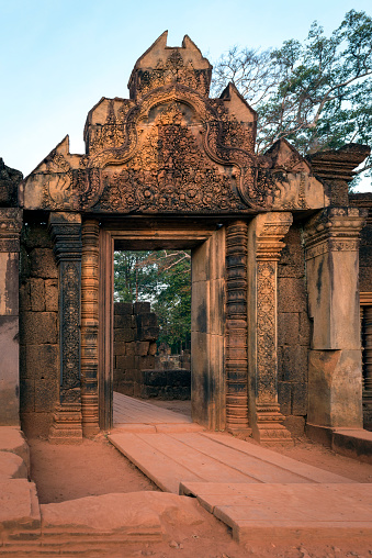 View of the gate to the ancient Hindu temple in early morning light at Prasat Banteay Srei, near Angkor Wat in Cambodia.