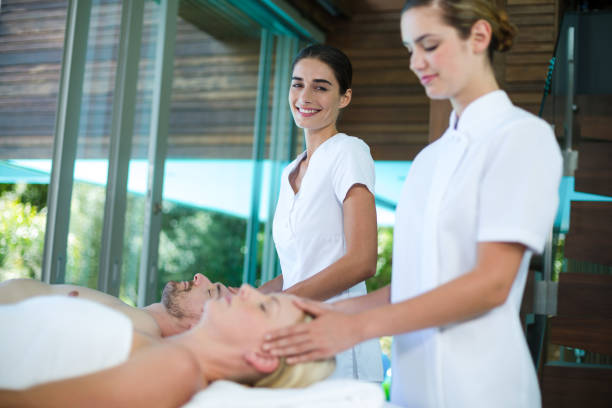 istock Couple receiving head massage from masseur 673289394