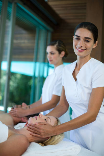 istock Woman receiving a face massage from masseur 673291750