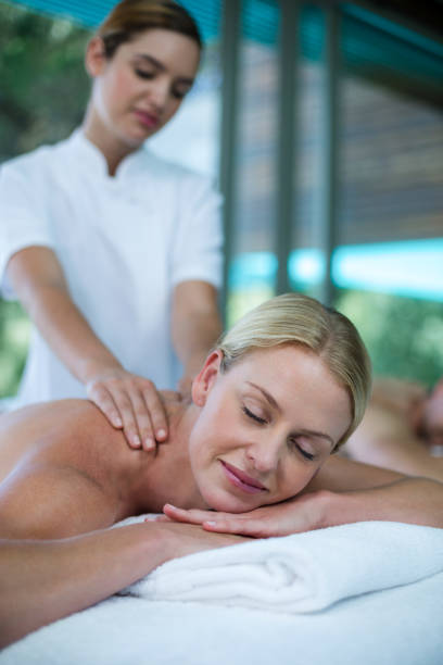 istock Woman receiving back massage from masseur 673294740