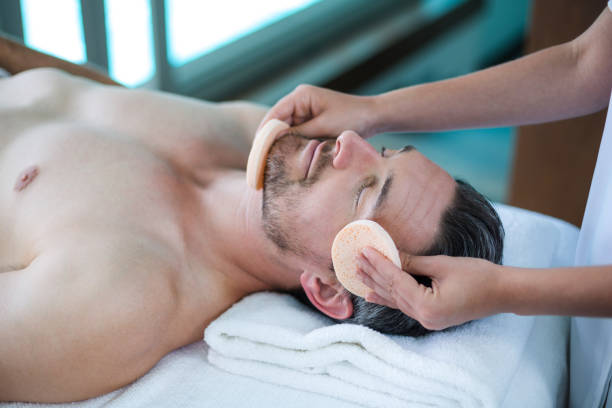 istock Man receiving a facial massage from masseur 673298076