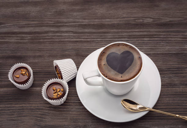 istock Cup of coffee with shape heart on wooden table. 673298304