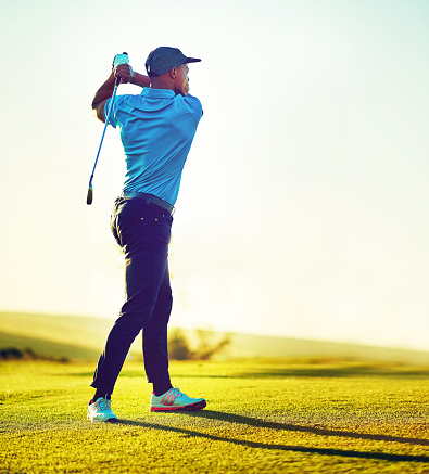 Shot of a young man playing golf