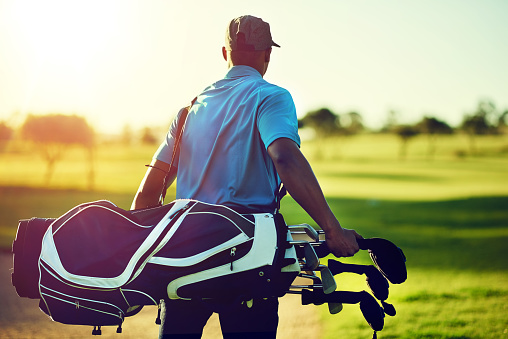 Shot of a young man playing golf