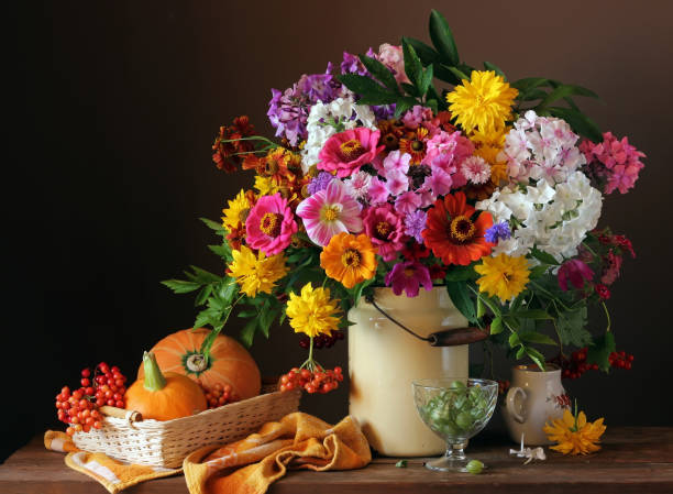istock Still life with a bouquet, pumpkins and berries 673304658
