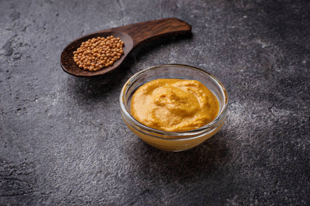 istock Mustard and seeds on concrete background 673322534