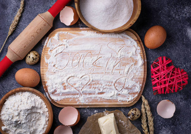 istock Egg, flour, sugar, butter and board with text Backing 673322642