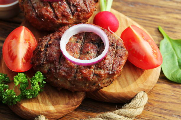 istock Homemade beef burger with onion on cutting board 673322704