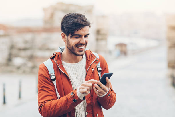 istock Cheerful traveler with smart phone 673323652