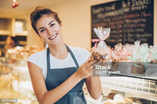 Beautiful Baker Holding A Cookies Package Stock Photo - Download Image Now - Christmas, Cookie, Bakery