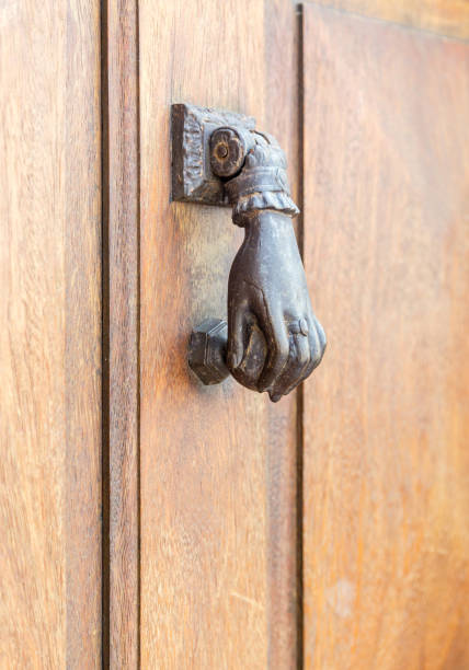 istock Old rustic vintage style door knocker in woman hand shape with ring 673325836