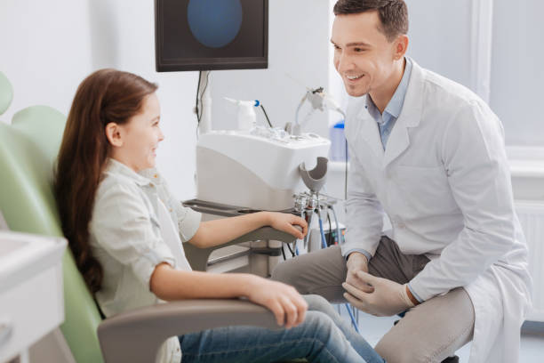 istock Positive delighted doctor looking at his patient 673326350