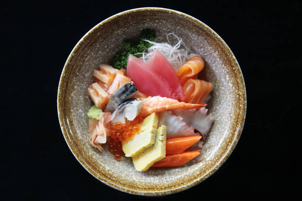istock Sushi don , raw salmon tuna octopus and egg on rice 673326528