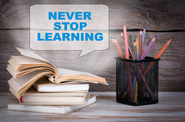 istock Never Stop Learning. Stack of books and pencils on the wooden table. 673326760