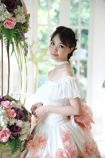 istock Asian Bride in white dress 673330010