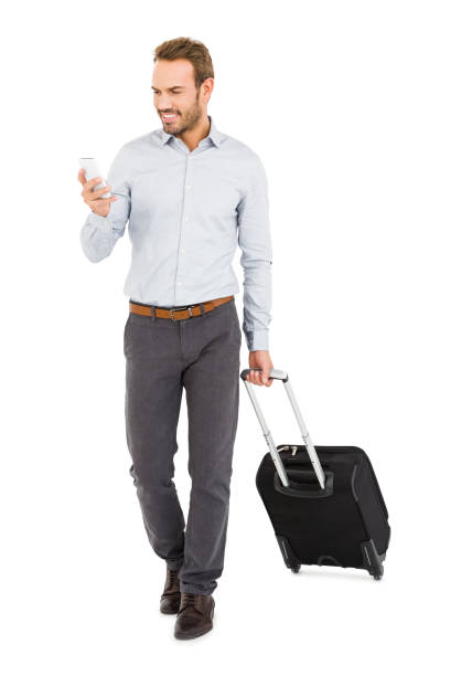 istock Young man holding trolley bag and using mobile phone 673330768
