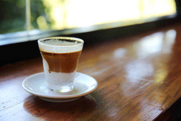 istock cappuccino coffee on wood background 673331126