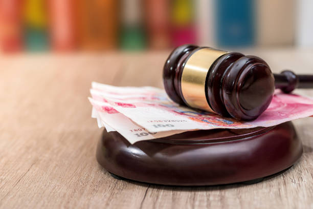 istock chinese yuan with wooden hammer on desk. 673335850