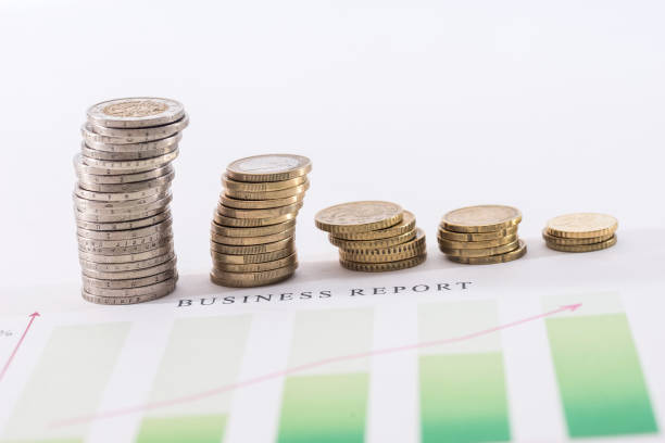 istock euro coin above business graph isolated on white 673344274