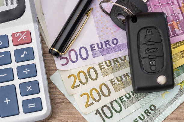 istock euro bills with car key and calculator. 673344422