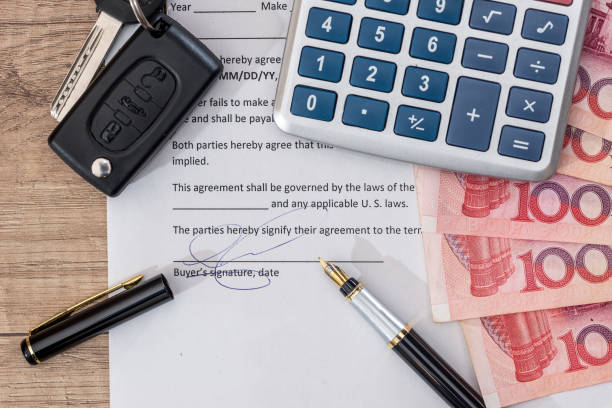 istock document, yuan bills, pen and car key on desk. 673347418