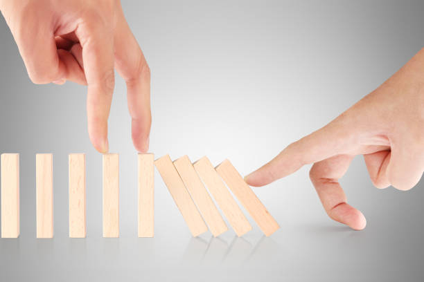 istock hand stop  dominoes continuous toppled 673350446