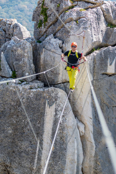 istock Young man on tibetan bridge on sunny day 673350450