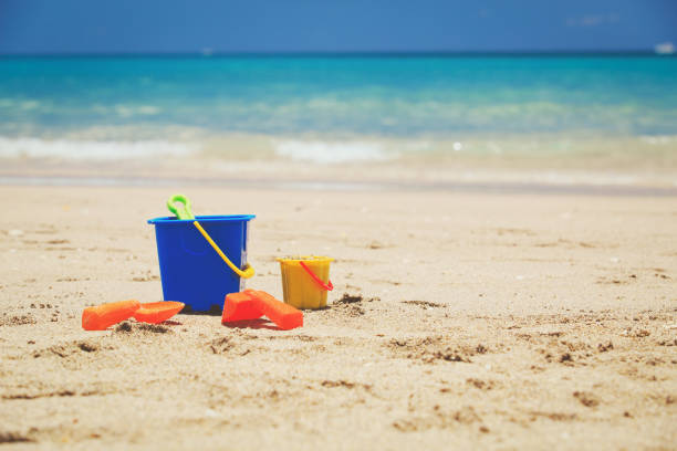 istock kid toys on tropical sand beach 673354360