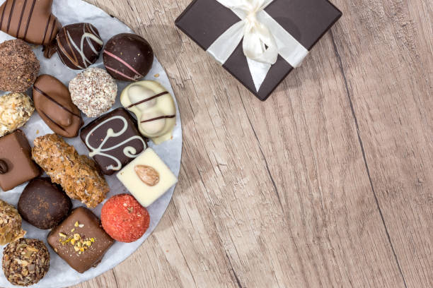 istock delicious sweets with cup of cappuccino and present box on desk. 673356776
