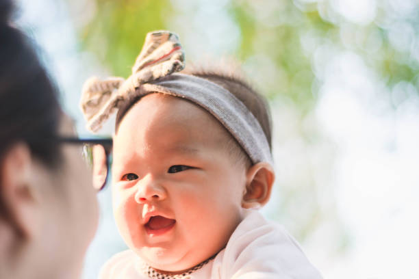 istock cute baby enjoy playing with aunt at park 673357876