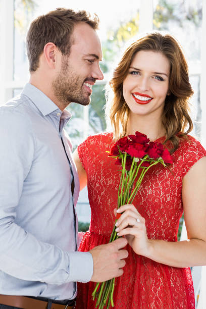 istock Man offering flower bouquet to woman 673365206