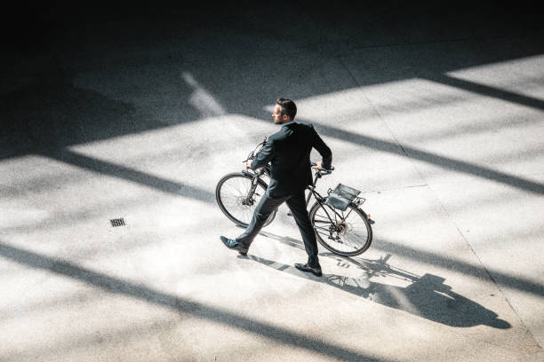 istock overhead view on elegant businessman going with bycicle outdoors 673371810