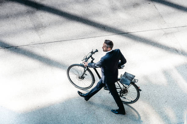 istock overhead view on handsome businessman going with bycicle to work 673371912