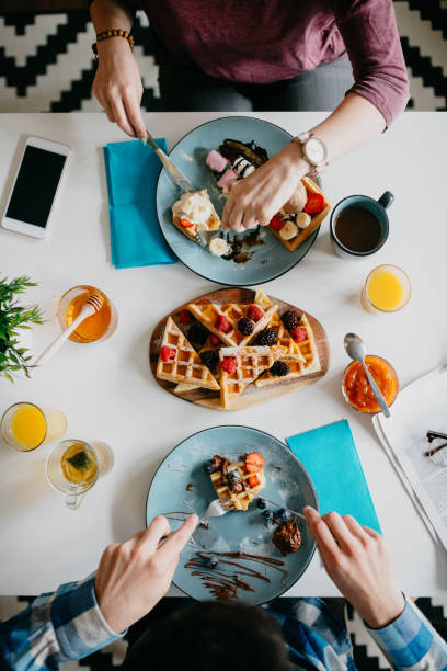 istock A Couple is eating waffle's for breakfast 673372178