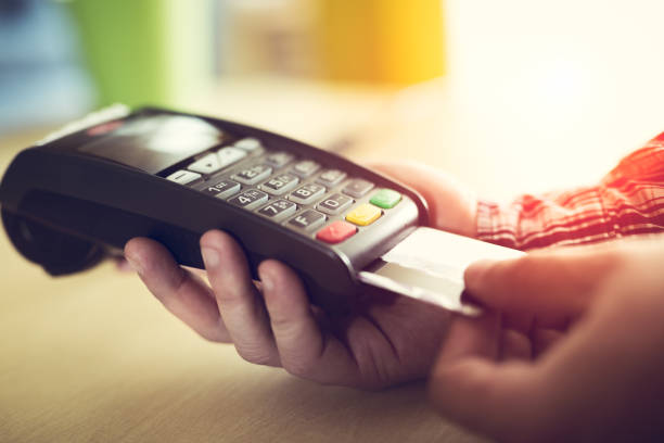 istock Close-up of a person using a credit card payment system 673372588