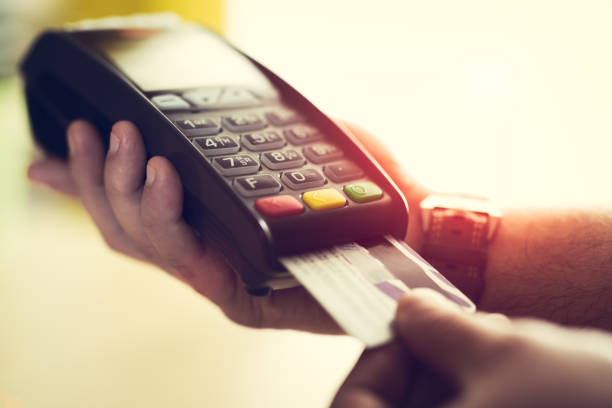 istock Close-up of a person using a credit card payment system 673372662