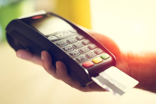 istock Close-up of a person using a credit card payment system 673374752