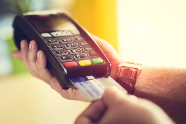 istock Close-up of a person using a credit card payment system 673374878