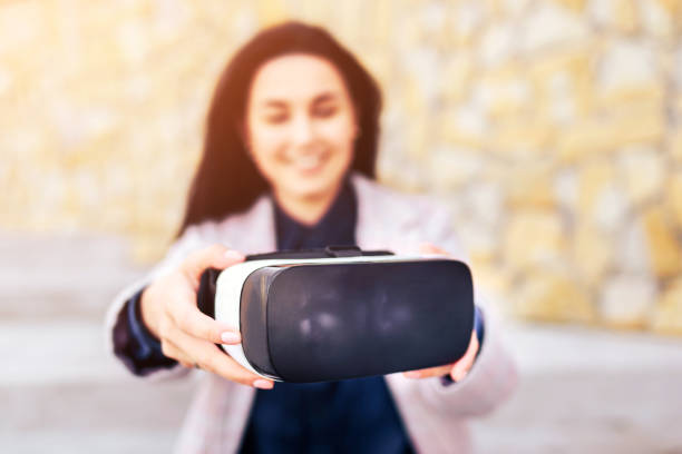 istock Woman in virtual reality glasses outdoor 673376224