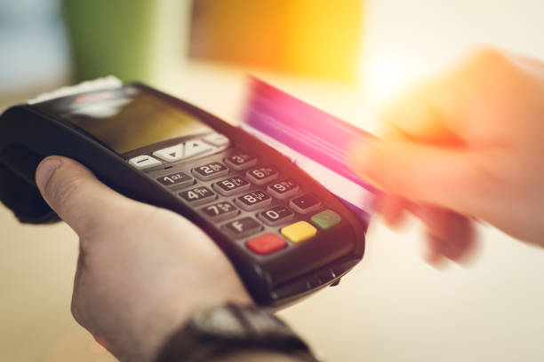 istock Hand Swiping Credit Card on POS terminal in Store 673376370